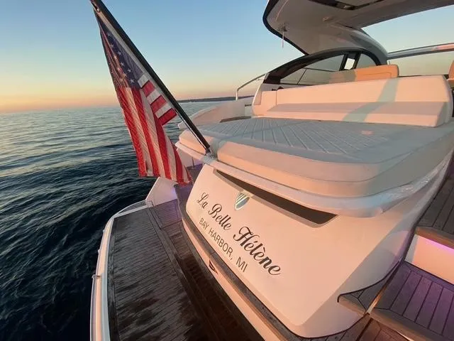 Slide: The Image of 2020 Fairline 45/43 Targa yacht with American flag, sunset view on calm waters. - 7