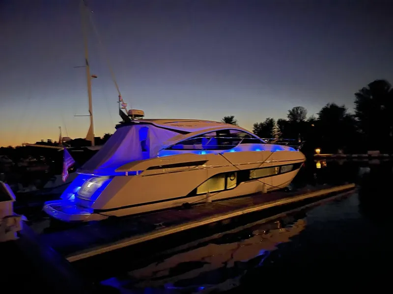 Slide: The Image of 2020 Fairline 45/43 Targa yacht illuminated with blue lights at dusk. - 16