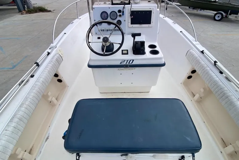 Slide: The Image of 2000 Seafox 21 CC boat interior with steering console and seating. - 12