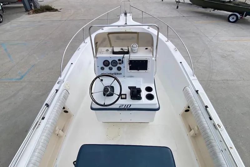Slide: The Image of 2000 Seafox 21 CC boat interior with steering wheel and control panel. - 13