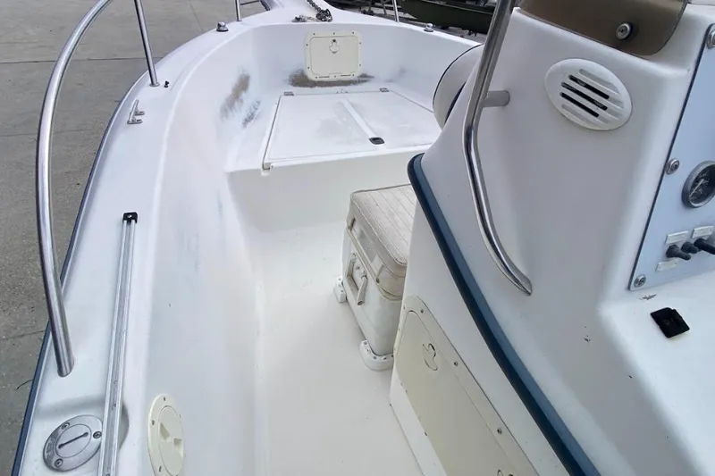 Slide: The Image of 2000 Seafox 21 CC boat interior with seating and control panel. - 15