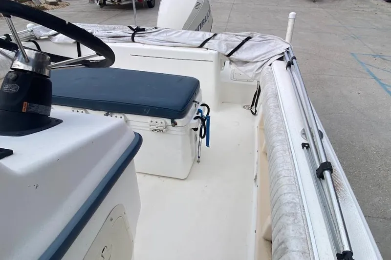 Slide: The Image of 2000 Seafox 21 CC boat interior with steering wheel and seating area. - 16