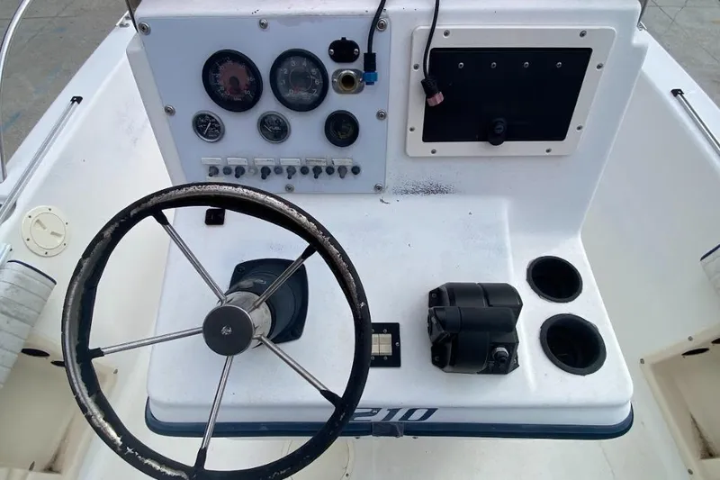 Slide: The Image of Steering console of a 2000 Seafox 21 CC boat with gauges and controls. - 18