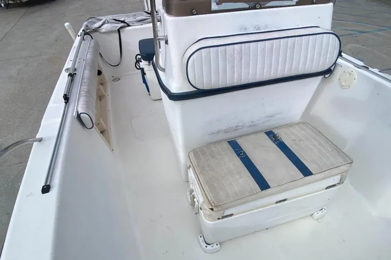 Slide: The Image of 2000 Seafox 21 CC boat interior with seating and storage compartments. - 19