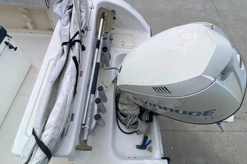 Slide: The Image of Seafox 21 CC boat with Evinrude outboard motor and fishing rod holders, 2000 model. - 21