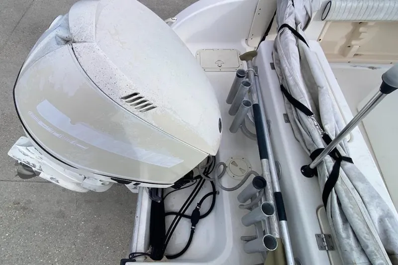 Slide: The Image of Outboard motor and fishing rod holders on a 2000 Seafox 21 CC boat. - 22
