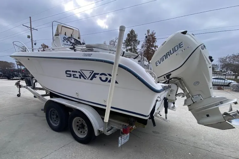 Slide: The Image of 2000 Seafox 21 CC boat on trailer with Evinrude outboard motor. - 5