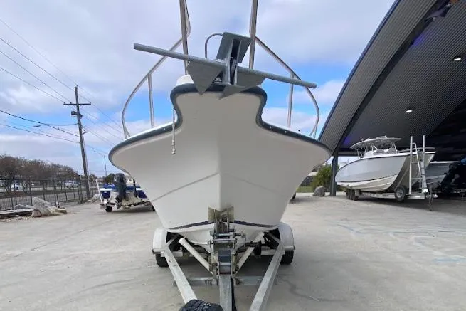 Slide: The Image of Front view of a 2000 Seafox 21 CC boat on a trailer at a marina. - 8