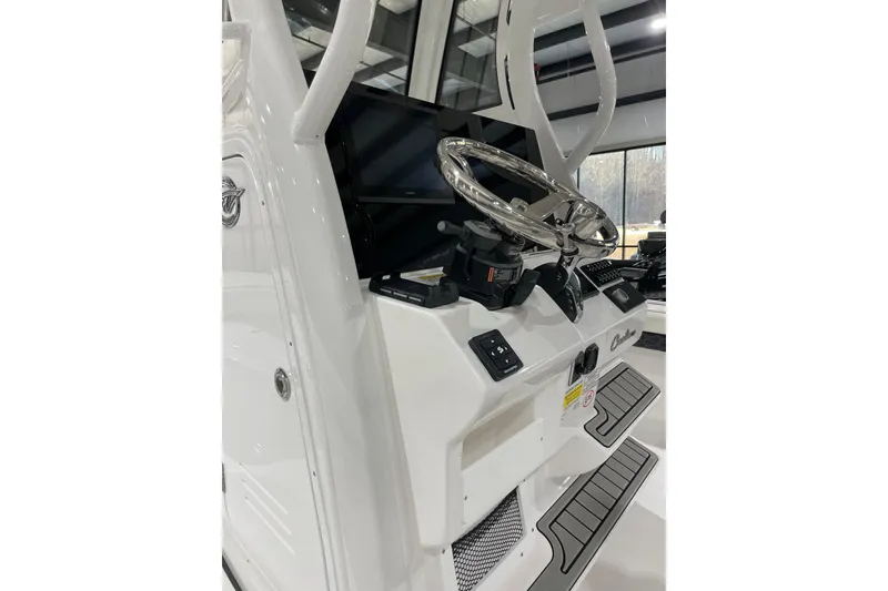 Slide: The Image of 2026 Tidewater 2500 Carolina Bay boat console with steering wheel and controls. - 3
