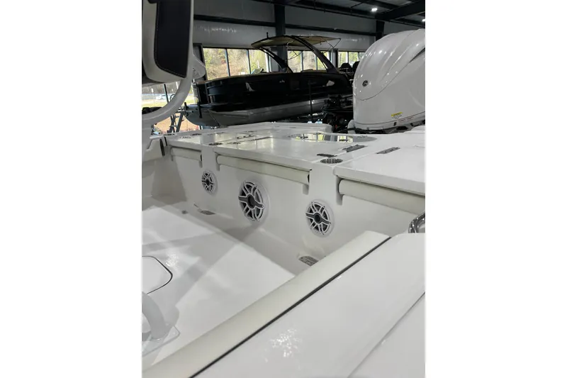 Slide: The Image of 2026 Tidewater 2500 Carolina Bay boat interior with speakers and seating in a showroom. - 5