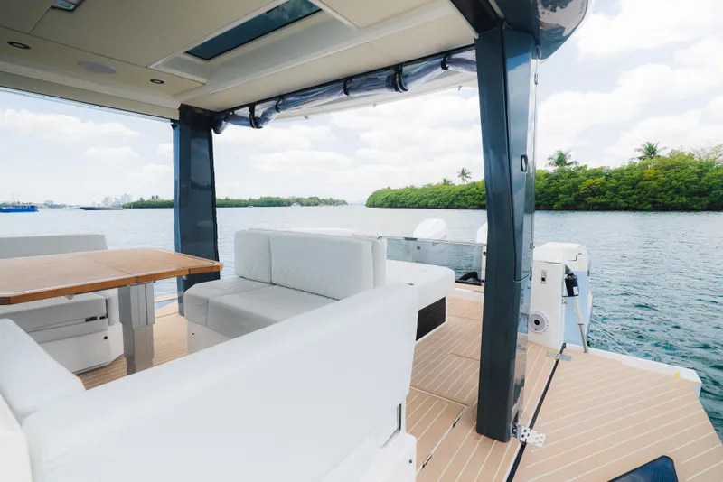 Slide: The Image of 2024 Saxdor 400 GTO boat interior with white seating and scenic water view. - 14