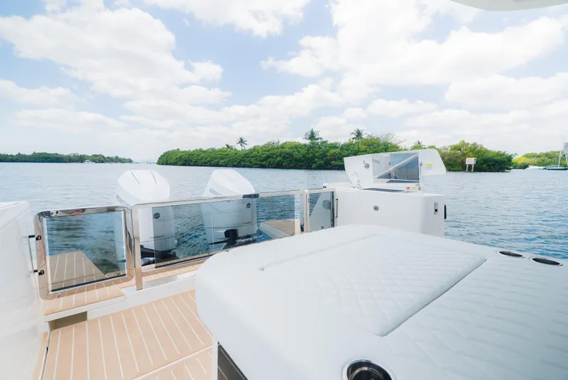 Slide: The Image of 2024 Saxdor 400 GTO boat with sleek design, featuring outdoor kitchen area by the water. - 18