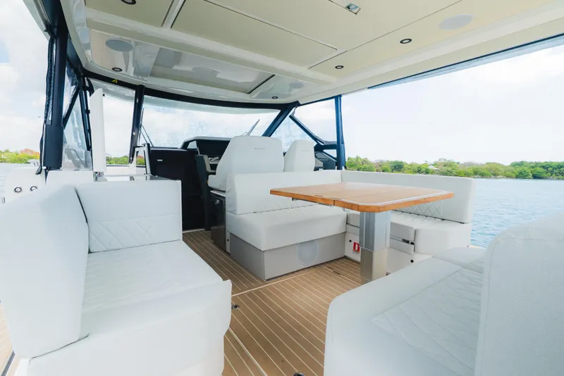 Slide: The Image of 2024 Saxdor 400 GTO boat with dual engines on a serene waterway. - 19