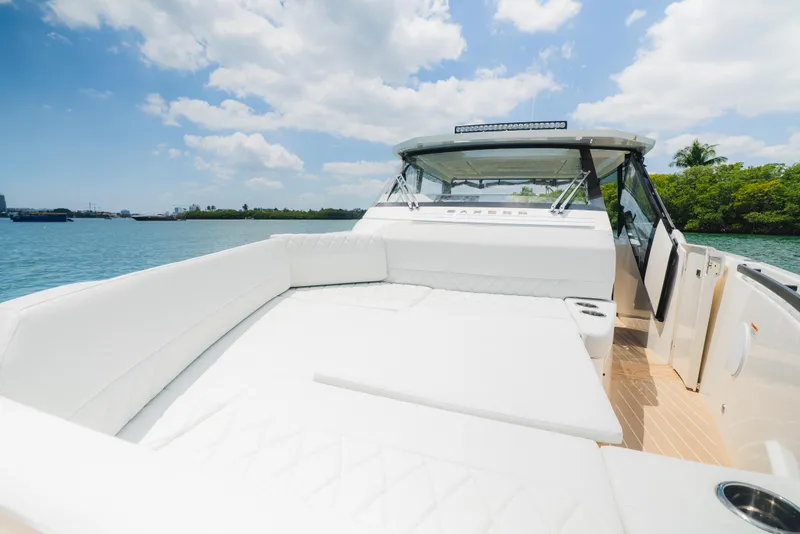 Slide: The Image of 2024 Saxdor 400 GTO boat with sleek deck design on calm blue water. - 29