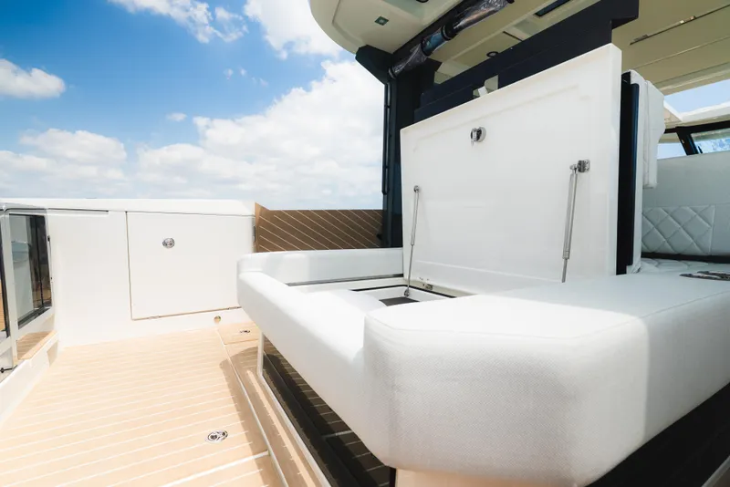 Slide: The Image of 2024 Saxdor 400 GTO boat with luxurious seating and table on a sunny day. - 31