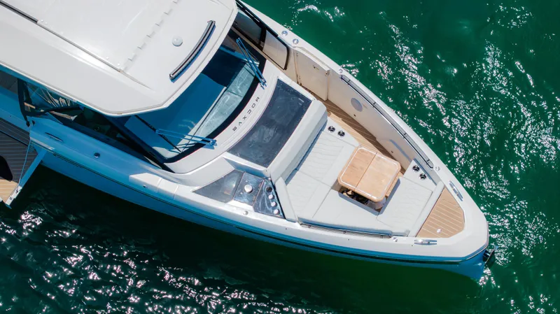 Slide: The Image of 2024 Saxdor 400 GTO luxury boat on water, featuring spacious deck and twin Mercury engines. - 4