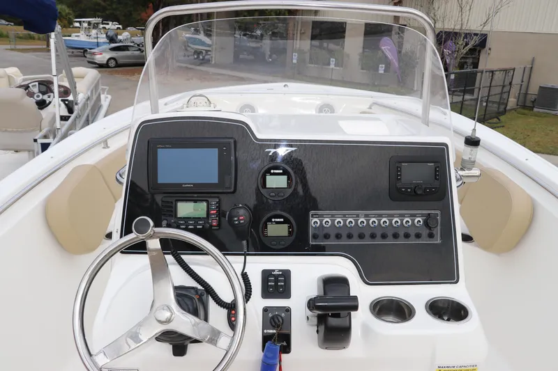 Slide: The Image of 2016 Tidewater 220 LXF boat with Yamaha 200 engine and storage compartments. - 10