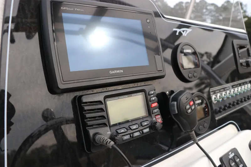 Slide: The Image of Interior view of a 2016 Tidewater 220 LXF boat, featuring beige seating and wiring details. - 12