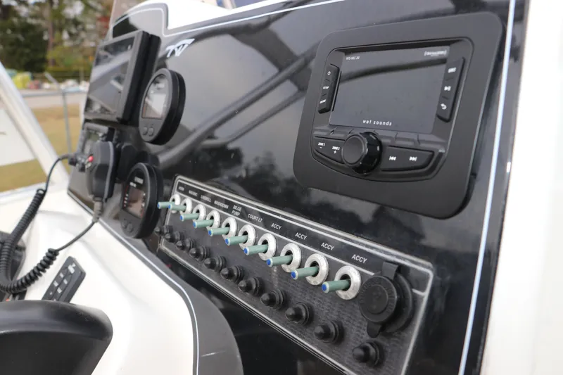 Slide: The Image of Tidewater 220 LXF 2016 boat seat with beige upholstery and stainless steel frame. - 13