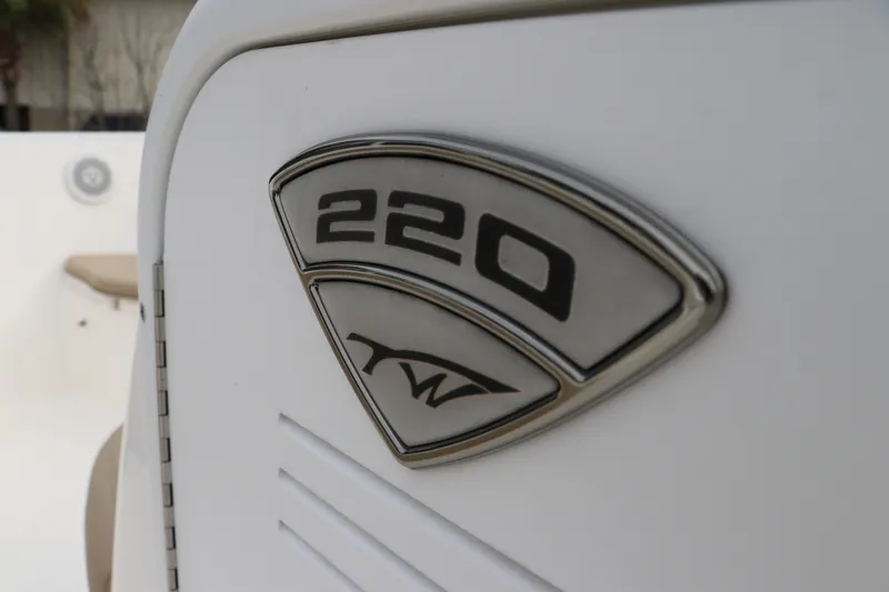 Slide: The Image of 2016 Tidewater 220 LXF boat dashboard with steering wheel and navigation controls. - 15