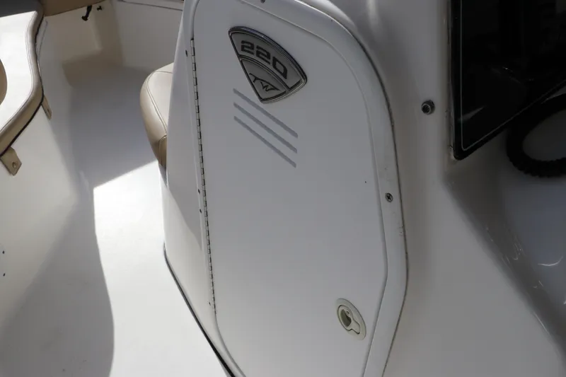 Slide: The Image of 2016 Tidewater 220 LXF boat console with steering wheel and controls. - 16
