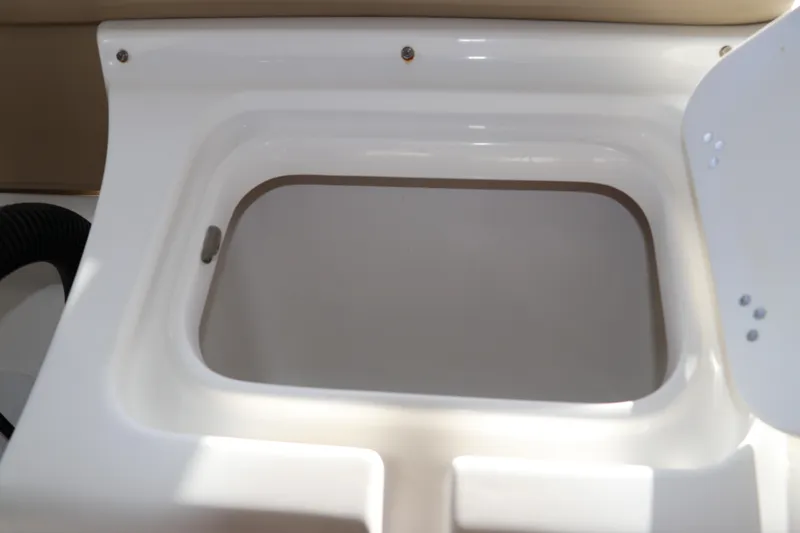 Slide: The Image of 2016 Tidewater 220 LXF boat with Yamaha engine, parked outdoors near trees. - 3