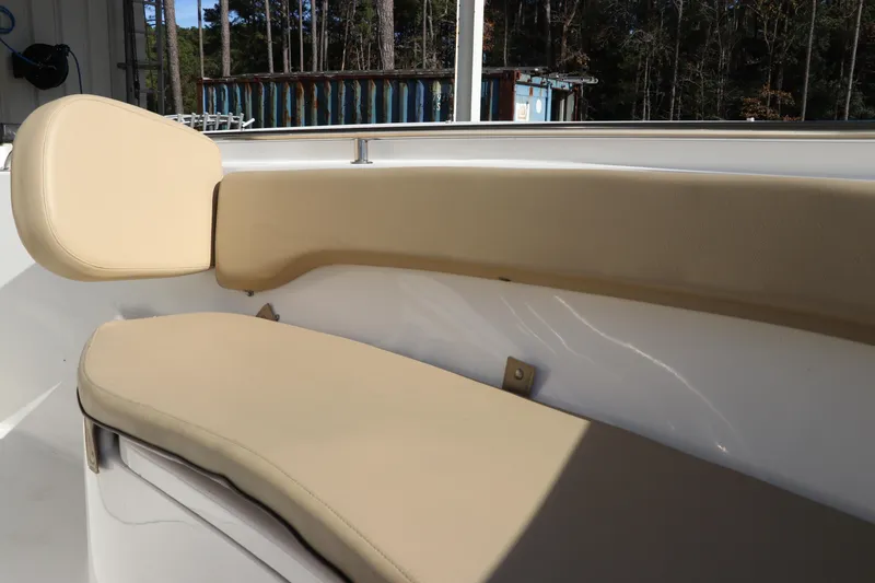 Slide: The Image of 2016 Tidewater 220 LXF boat interior with beige seating and backrest. - 31