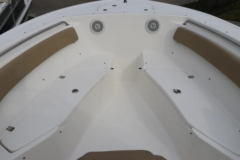 Slide: The Image of 2016 Tidewater 220 LXF boat interior with tan seating and storage compartments. - 32