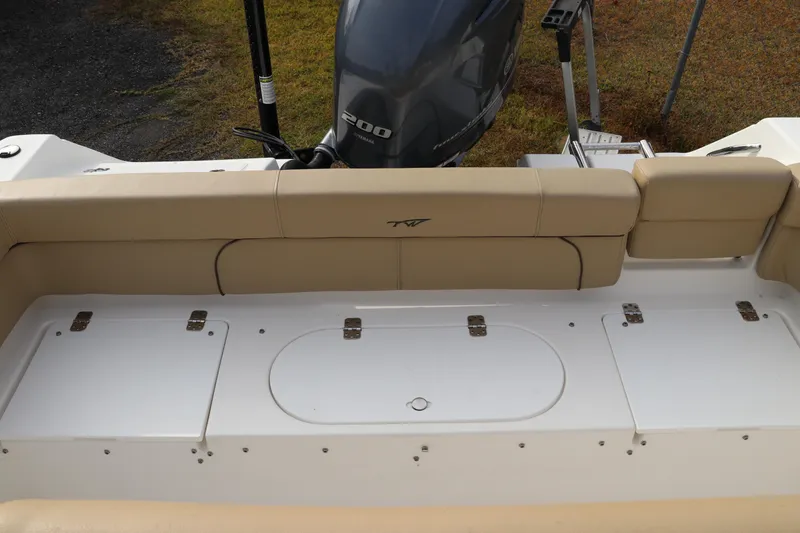 Slide: The Image of Cooler compartment on 2016 Tidewater 220 LXF boat, featuring secure latch and hinges. - 5