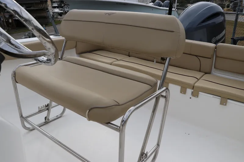 Slide: The Image of 2016 Tidewater 220 LXF boat with Yamaha 200 engine, featuring beige seating and storage compartments. - 8