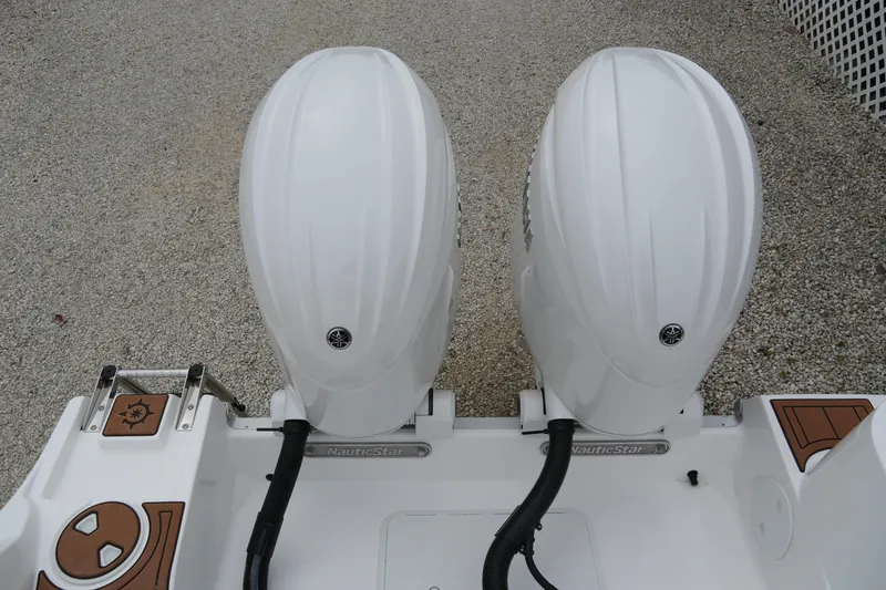 Slide: The Image of 2025 NauticStar 252 Legacy boat with dual outboard engines, rear view. - 11
