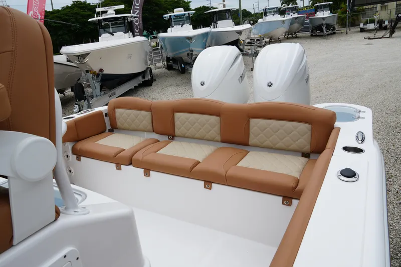 Slide: The Image of 2025 NauticStar 252 Legacy boat with tan seating and dual engines. - 12