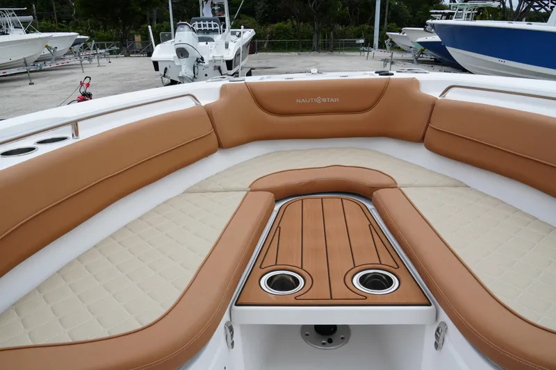 Slide: The Image of 2025 NauticStar 252 Legacy boat interior with tan seating and wood accents. - 15