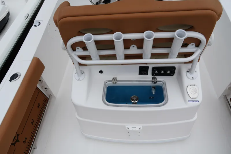 Slide: The Image of 2025 NauticStar 252 Legacy boat interior with rod holders and livewell. - 22