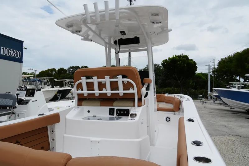 Slide: The Image of 2025 NauticStar 252 Legacy boat interior with tan seating and modern helm. - 23
