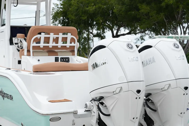 Slide: The Image of 2025 NauticStar 252 Legacy boat with dual Yamaha 150 engines, rear seating view. - 6