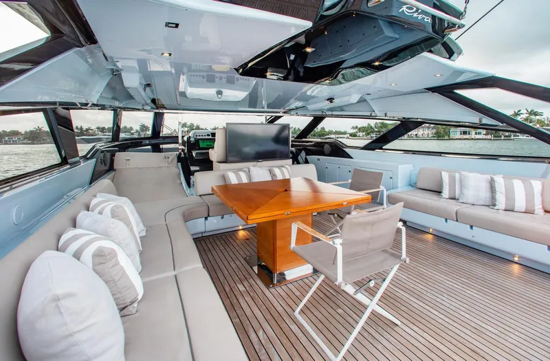 Slide: The Image of Luxurious 2016 Riva 88' Florida yacht interior with elegant seating and wooden table. - 23