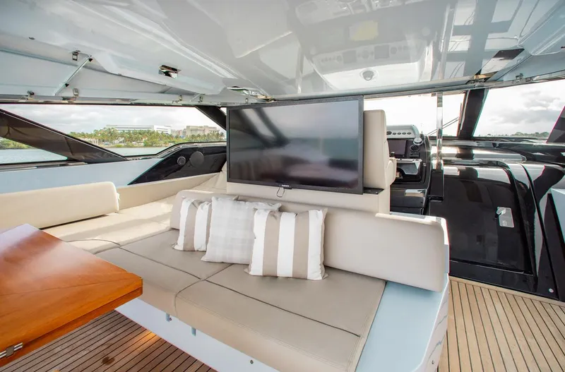 Slide: The Image of Luxurious interior of 2016 Riva 88' Florida yacht with plush seating and TV. - 25