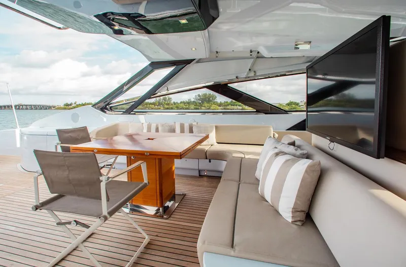 Slide: The Image of Luxurious 2016 Riva 88' Florida yacht deck with seating, table, and TV. - 26