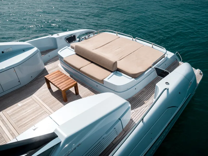 Slide: The Image of Luxury 2016 Riva 88' Florida yacht deck with sunbed and wooden table. - 34