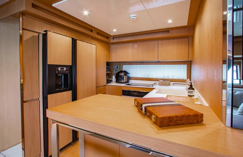 Slide: The Image of Luxurious kitchen interior of 2016 Riva 88' Florida yacht with modern wood finishes. - 8