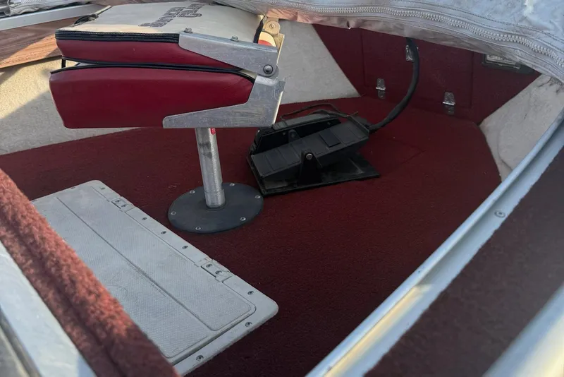Slide: The Image of 1988 Smoker Craft Magnum 162 boat interior with red carpet and adjustable seat. - 4