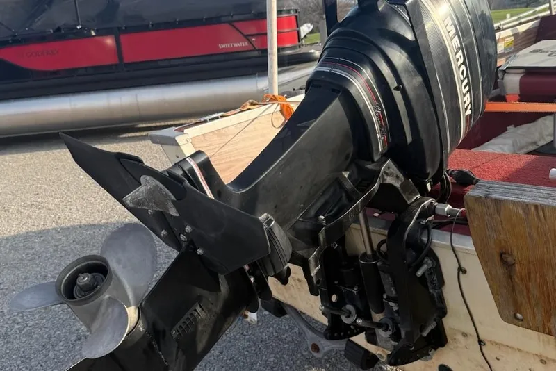 Slide: The Image of 1988 Smoker Craft Magnum 162 with Mercury outboard motor, close-up view. - 6