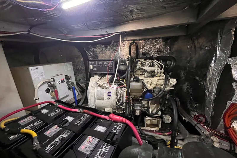 Slide: The Image of Engine room of a 2001 Silverton 42C boat with batteries and wiring. - 101