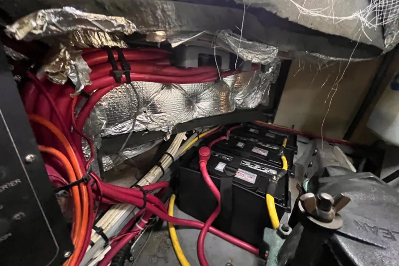 Slide: The Image of Engine room of a 2001 Silverton 42C with batteries and wiring. - 102