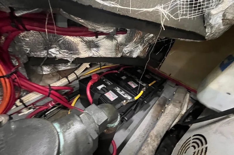 Slide: The Image of Engine room of a 2001 Silverton 42C boat with visible wiring and battery. - 103