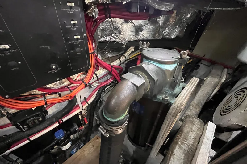 Slide: The Image of Engine room of a 2001 Silverton 42C boat, showing wiring and mechanical components. - 104