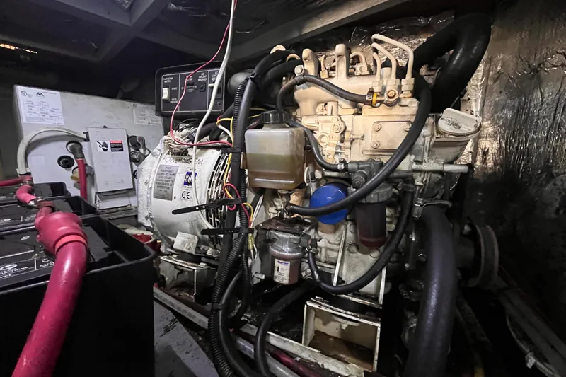 Slide: The Image of Engine room of a 2001 Silverton 42C boat, showcasing mechanical components and wiring. - 105