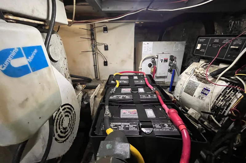 Slide: The Image of Engine room of a 2001 Silverton 42C with Cummins Marine components and battery system. - 106