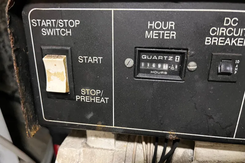 Slide: The Image of Control panel of a 2001 Silverton 42C boat with hour meter and switches. - 108